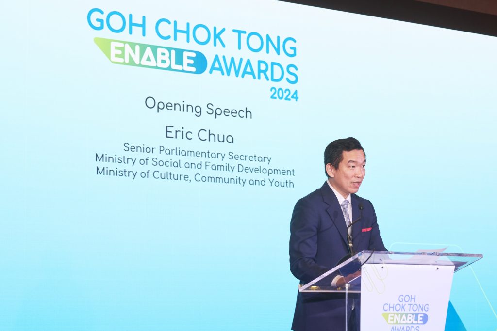 Photo shows Senior Parliamentary Secretary Eric Chua giving a speech